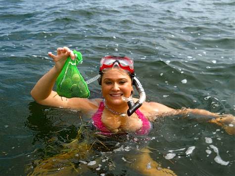 Melissa with a bag of scallops caught while scalloping in florida out of homasassa