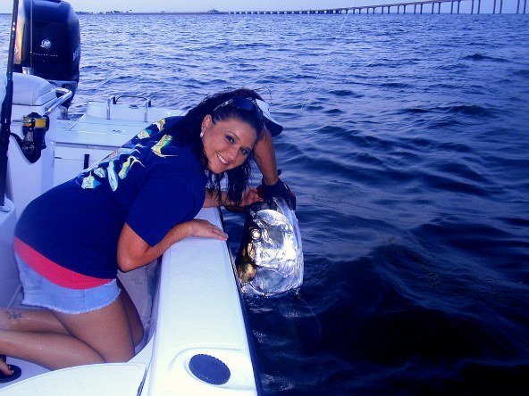 melissa witha 140lb tarpon caught while florida tarpon fishing near the sunshine skyway bridge during the spring and summer tarpon season